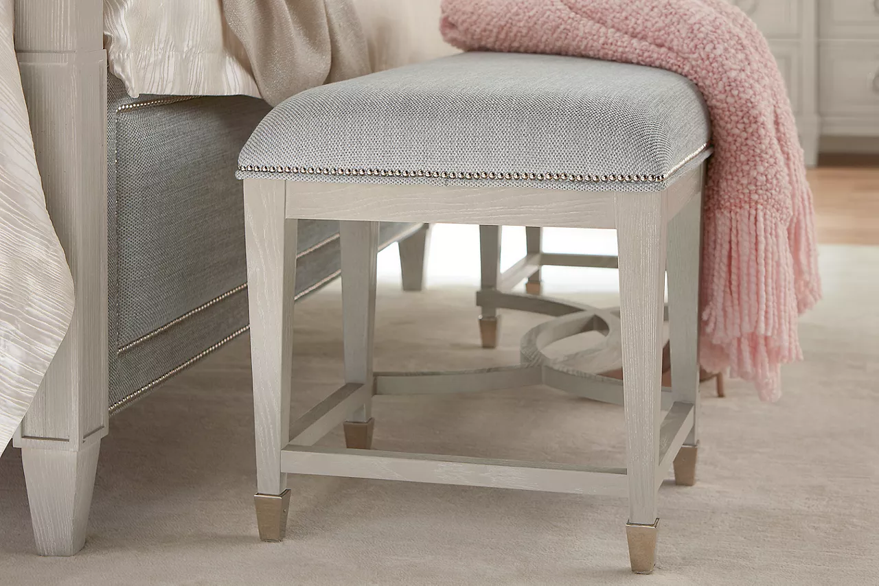 Closeup of a Hyde Park Bench to show the fabric seat with the nailhead trim in a room scene.
